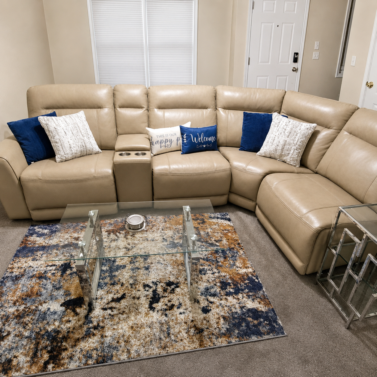 Welcoming living room with sectional seating and a glass coffee table